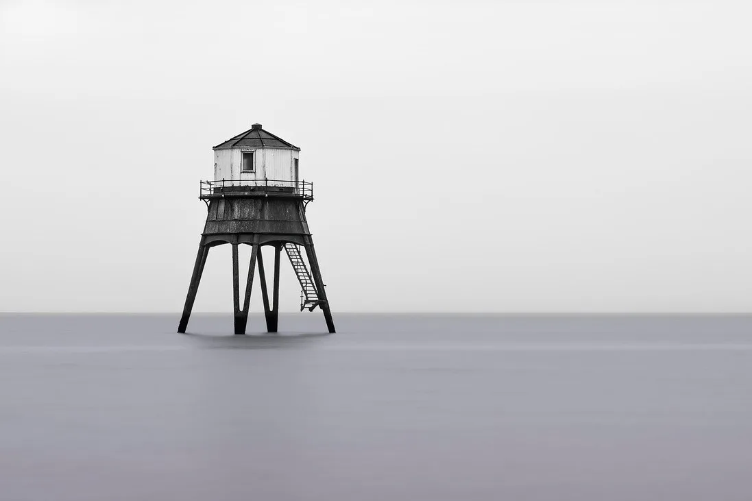 Lone lighthouse in a calm ocean